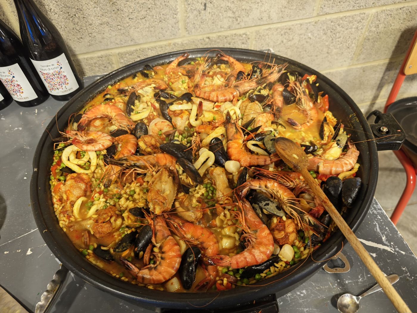 Homemade paella with prawns, mussels, squid and peas