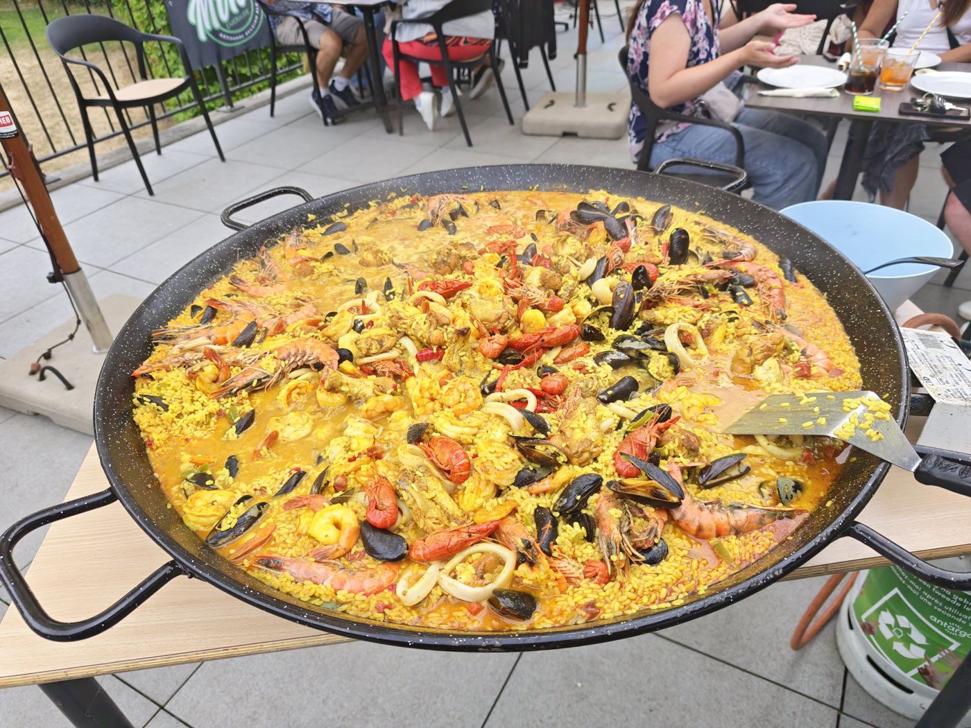Homemade paella with crayfish, prawns and mussels in a large pan